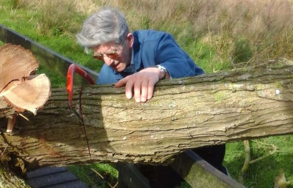 David Proctor cutting wood saw hacksaw farm organic fordhall