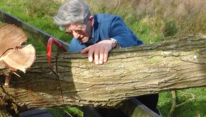 David Proctor cutting wood saw hacksaw farm organic fordhall